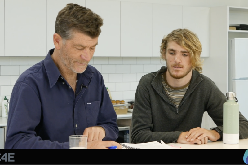 Two guys looking at book