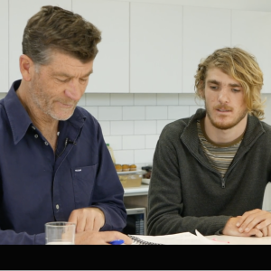 Two guys looking at book